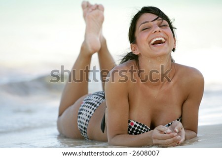 stock photo playful brunette model lying on the beach