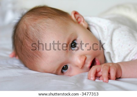 stock photo : Cute 6 Months old mixed baby girl trying to stand up