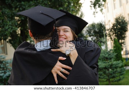 A graduates in the mantle embrace and enjoy. Beautiful graduate girl and boy enjoyed the ceremony graduation.