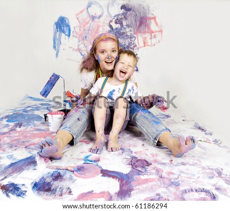 Mother and son paint the walls