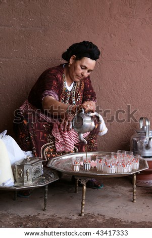 MARRAKECH, MOROCCO - AUGUST 8 : A Berber woman performs the traditional ceremony of making mint tea on August 8, 2008 in Marrakech, Morocco. This was a demonstration of Berber life made to tourists.