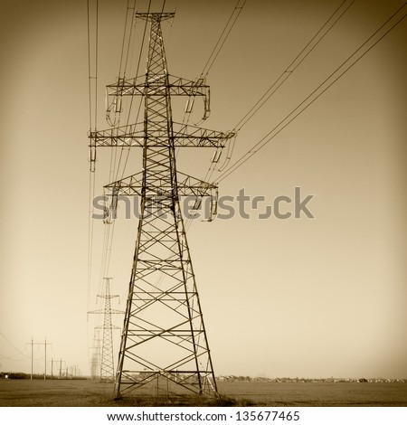 Super wide angle photograph of a row of power lines against a blue sky. Vintage