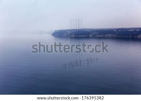 Fog. Seascape with fishing nets with the effect of film grain. Image shows a nice grain pattern at 100 percent.