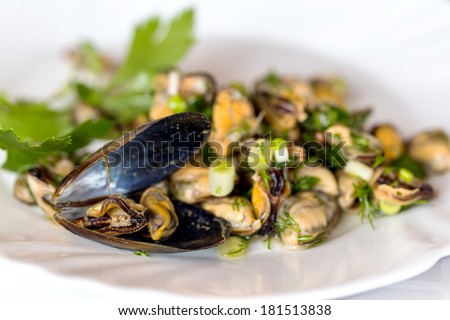 creative serving fried mussels with herbs, selective focus