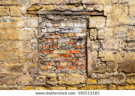 Vintage background old wall with a window laid bricks