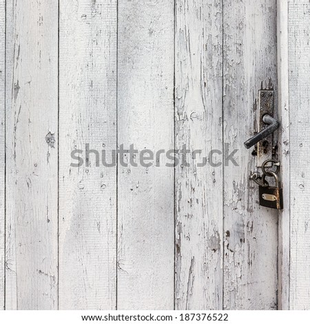 Old wooden door with metal lock and handle