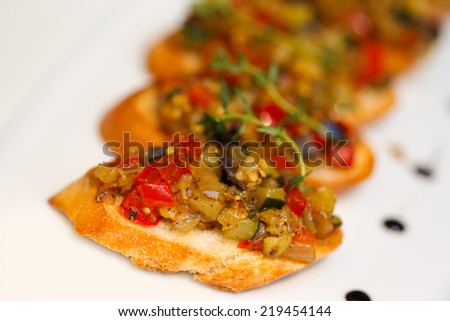 Bruschetta (Italian Toasted Garlic Bread) with stewed vegetables, selective focus. Creative cuisine.