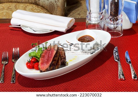 Medium Grilled bbq steaks and savory tomato sauce