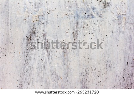 Dirty concrete wall with yellow streaks of water, cracks and scratches. Grungy concrete surface. Great background or texture for your project.