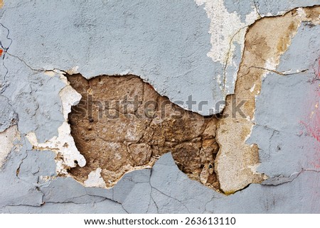 Creative background concrete wall with cracks and scratches painted gray paint, needs urgent repair. For creative unusual vintage design
