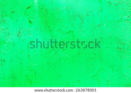Bright abstract background old metal surface sloppy paint green paint with highlights, streaks, scratches and cracks