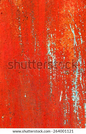 Creative background of rusty metal with cracks and scratches, carelessly painted red paint. Grungy metal surface. Great background or texture for your project.