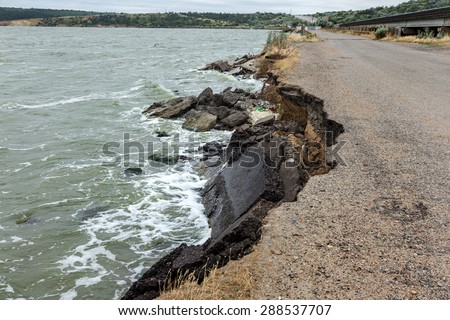 Due to violations of technology in the construction of roads, water, more rain and huge waves of the sea during a storm split and broke and washed away the asphalt road and formed a landslide failure