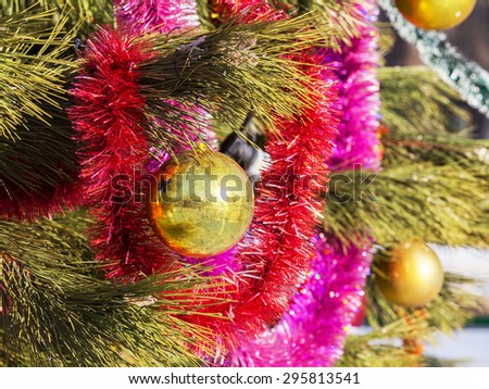 Authentic pine branch decorated with Christmas old baubles, selective soft focus as a background for a Christmas design.