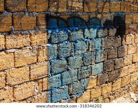 ODESSA - SEPTEMBER 15: Detail of graffiti on the stone wall of an old building in the future. The rough stone surface with cracks, scratches and streaks of paint. September 15, 2015 in Odessa