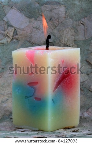 decorative scented candles on a background of dry pressed leaf