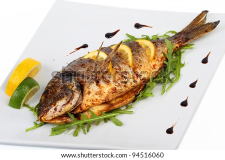 fried fish with fresh herbs and lemon