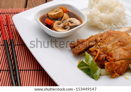 Asian fried chicken with rice and paprika mushrooms sauce