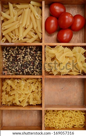 Old wooden box with pasta ingredients