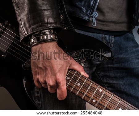 Rock star with an old scratched guitar