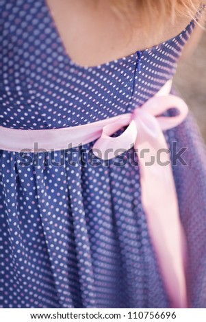 rosy ribbon on the blue dress