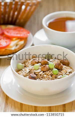 light breakfast with tea, fruit, sandwich and porridge