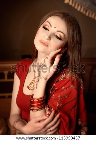 Beauty portrait of a young indian woman in traditional clothing with bridal makeup and jewelry
