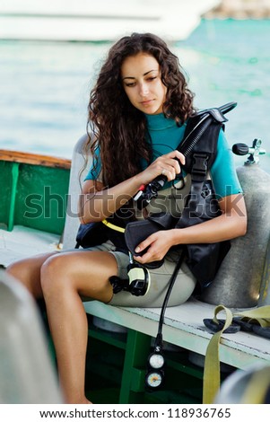 beautiful woman checking diving. dive equipment