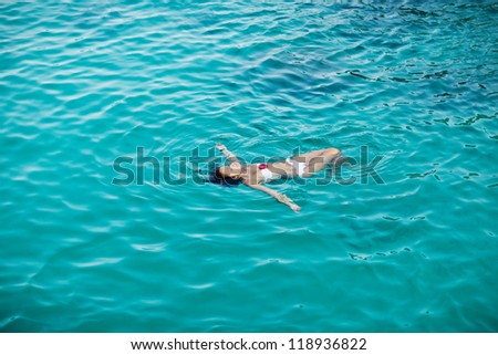 woman relaxing in tropical ocean water happy and free
