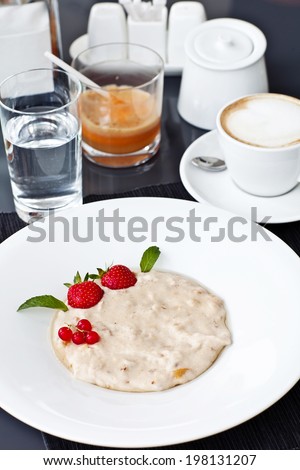 Semolina porridge in a plate with fresh strawberries. Health Breakfast