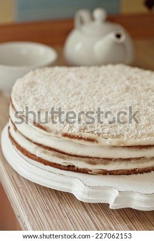 series of winter coconut cake. Decorate with strawberry, coconut and forest cone