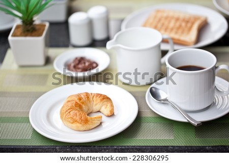 Hotel breakfast. croissant and coffee with milk