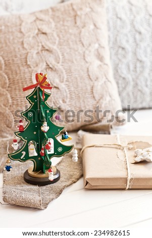 Green new year tree with pillow and present