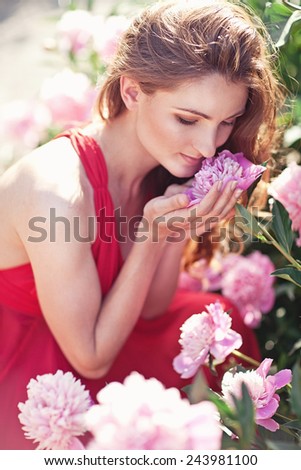 Beautiful woman with peony flowers,outdoor. Spring mood.