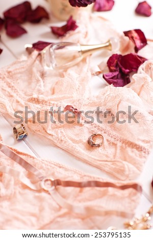 Tenderness peachys lingerie with roses petails, candle and accessories. Love mood.