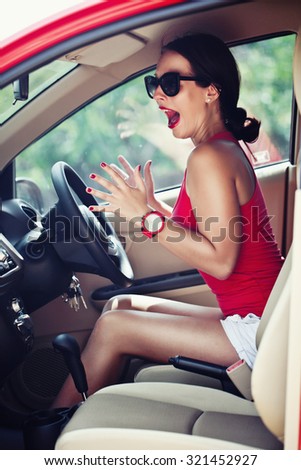 Beautiful woman panic in the red car