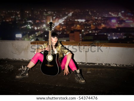 stock-photo-young-girl-with-a-guitar-on-a-roof-of-a-high-rise-building-54374476.jpg