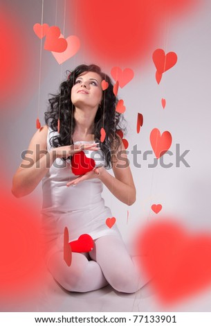 woman with red heart balloon on a white background