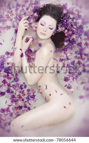 Attractive naked girl enjoys a bath with milk and rose petals Spa treatments for skin rejuvenation Attractive naked girl enjoys a bath with milk and rose petals Spa treatments for skin rejuvenation