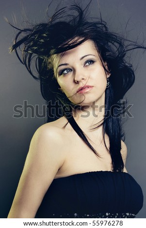 Portrait of a young beautiful woman with fluttering hair.