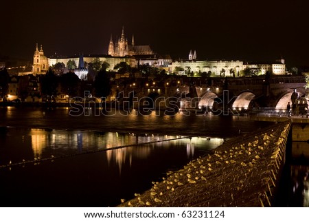 Prague at night. Castle and Charles Bridge, seen on the river Vltava