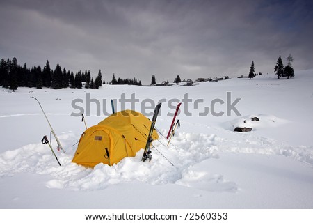 tent fitted with skis in snow in winter