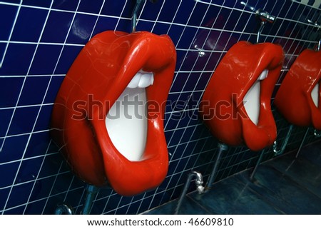 Toilet bowl made as red lips with a teeth at the comic entertaining restaurant