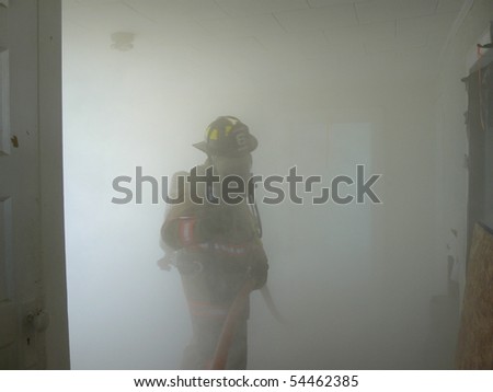 Firefighter in smoke filled room