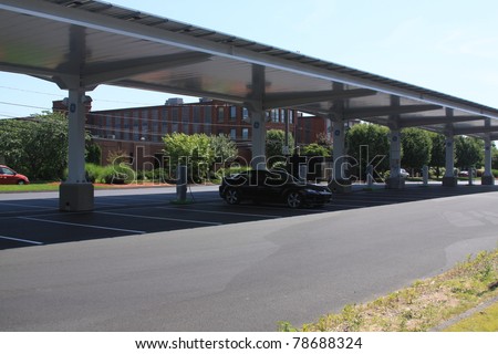 PLAINVILLE, CT., USA-MAY 28: General Electric Solar carport powers up-Electronic Carport, automobile charging station in Plainville, Connecticut, USA