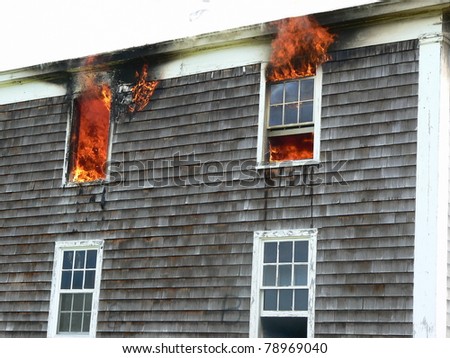 house fire with flames in windows