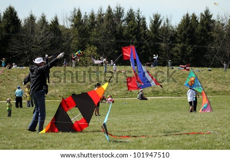 KORTRIGHT CENTER Ã¢Â?Â? MAY 06: Man with kite Four Winds Spring Kite Festival in May 06 2012 in Kortright Center in Ontario, Canada. Annual international  festival features participants and viewers.