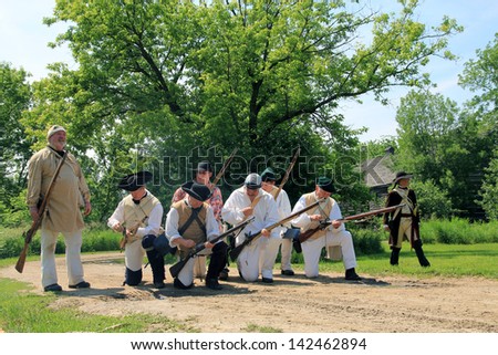 TORONTO - JUNE 15: Reenactment of the conflict of Revolutionary War between refugees and Loyalists at  Black Creek -  in June 15 2013 in Black Creek Village, Toronto, Canada