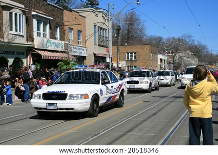 TORONTO - APRIL 12: Police cars parade on Toronto street at Easter parade April 12, 2009 in Toronto, Canada. More than 25,000 people attended the parade.