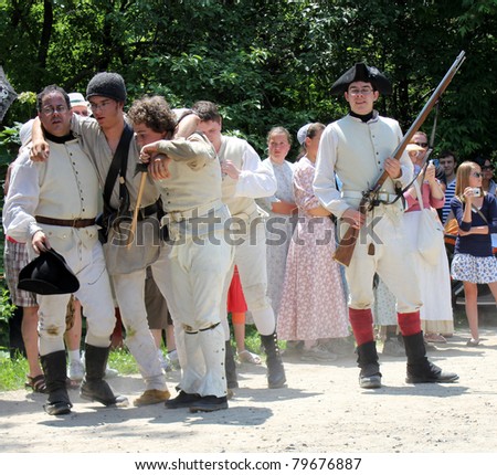 TORONTO – JUNE 18: Unidentified actors at reenactment of Revolutionary War between refugees and Loyalists on June 18, 2011 in Black Creek Village, Toronto
